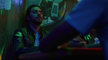 Movie still from “Full Circle” (2023), directed by Steven Soderbergh – A man sitting in front of a mirror in a room; Close Up shot, Low angle