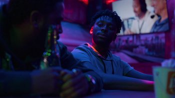Movie still from “Full Circle” (2023), directed by Steven Soderbergh – Two men sitting at a table in a dark room; Close Up shot, Over the shoulder angle