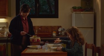 Movie still from “Petite Maman” (2021), directed by Céline Sciamma – A woman and a child are eating at a table; Medium shot, Over the shoulder angle