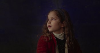 Movie still from “Petite Maman” (2021), directed by Céline Sciamma – A young girl looking up into the sky; Close Up shot, Low angle