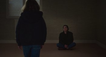 Movie still from “Petite Maman” (2021), directed by Céline Sciamma – A woman sitting on the floor in front of another woman; Wide shot, High angle