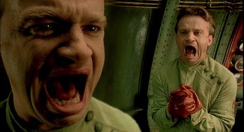 Movie still from “The City of Lost Children” (1995), directed by Jean-Pierre Jeunet – A man with his mouth wide open and his mouth wide open; Close Up shot, Low angle