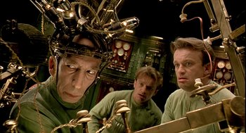 Movie still from “The City of Lost Children” (1995), directed by Jean-Pierre Jeunet – A group of people in a room with a lot of wires; Close Up shot, Low angle