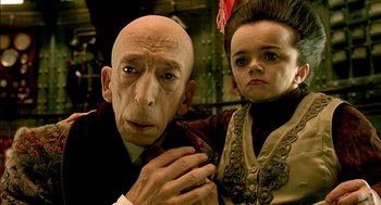 Movie still from “The City of Lost Children” (1995), directed by Jean-Pierre Jeunet – A man and a woman posing for a picture; Close Up shot, Low angle
