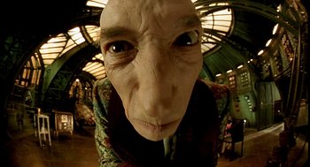 Movie still from “The City of Lost Children” (1995), directed by Jean-Pierre Jeunet – An old man with a strange face in a room; Extreme Close Up shot, Low angle