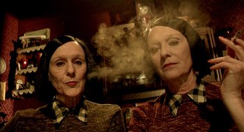 Movie still from “The City of Lost Children” (1995), directed by Jean-Pierre Jeunet – A couple of people that are looking at the camera; Close Up shot, Low angle