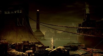 Movie still from “The City of Lost Children” (1995), directed by Jean-Pierre Jeunet – A boat in the middle of a harbor with a lighthouse in the background; Extreme Wide shot, High angle