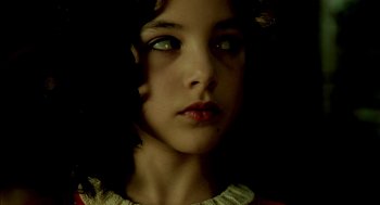 Movie still from “The City of Lost Children” (1995), directed by Jean-Pierre Jeunet – A young girl is looking into the camera; Close Up shot, High angle