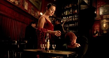 Movie still from “The City of Lost Children” (1995), directed by Jean-Pierre Jeunet – A woman standing at a table in front of a man; Medium shot, Low angle