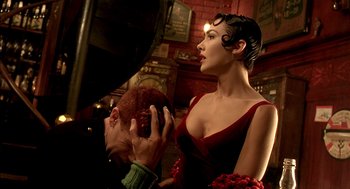 Movie still from “The City of Lost Children” (1995), directed by Jean-Pierre Jeunet – A woman in a red dress and a man in a black suit; Close Up shot, Over the shoulder angle