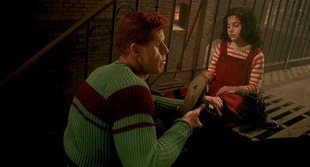 Movie still from “The City of Lost Children” (1995), directed by Jean-Pierre Jeunet – A man and a woman in a room with a brick wall; Medium shot, High angle