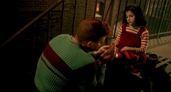 Movie still from “The City of Lost Children” (1995), directed by Jean-Pierre Jeunet – A man and a woman sitting on a bench; Medium shot, High angle