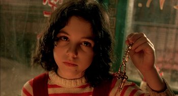 Movie still from “The City of Lost Children” (1995), directed by Jean-Pierre Jeunet – A young girl holding a pair of keys in her hand; Close Up shot, High angle