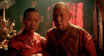 Movie still from “The City of Lost Children” (1995), directed by Jean-Pierre Jeunet – An older man standing next to an older woman; Close Up shot, Low angle