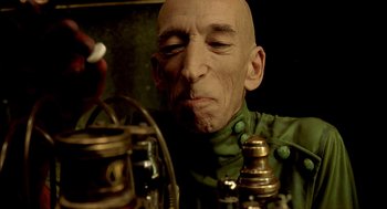 Movie still from “The City of Lost Children” (1995), directed by Jean-Pierre Jeunet – An old man is looking at a candle holder; Close Up shot, Low angle