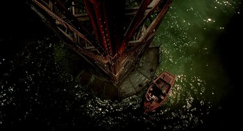 Movie still from “The City of Lost Children” (1995), directed by Jean-Pierre Jeunet – An aerial view of a boat under a bridge; Extreme Wide shot, Overhead angle