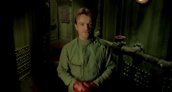Movie still from “The City of Lost Children” (1995), directed by Jean-Pierre Jeunet – A man in a green jacket and red gloves; Medium shot, Low angle