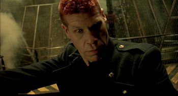 Movie still from “The City of Lost Children” (1995), directed by Jean-Pierre Jeunet – A man with red hair and a black shirt; Close Up shot, Low angle