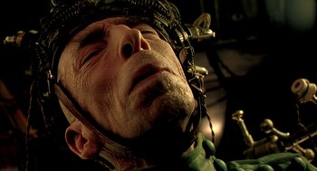 Movie still from “The City of Lost Children” (1995), directed by Jean-Pierre Jeunet – An older man with a helmet on his head; Extreme Close Up shot, Overhead angle