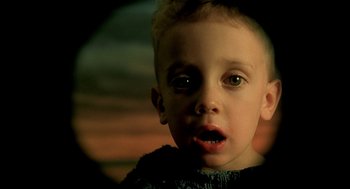 Movie still from “The City of Lost Children” (1995), directed by Jean-Pierre Jeunet – A young boy with a surprised look on his face; Close Up shot, High angle