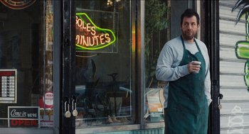 Movie still from “The Cobbler” (2014), directed by Tom McCarthy – A man standing in front of a store window; Medium shot, Over the shoulder angle