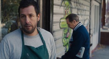 Movie still from “The Cobbler” (2014), directed by Tom McCarthy – A man standing next to another man outside; Medium shot, Over the shoulder angle