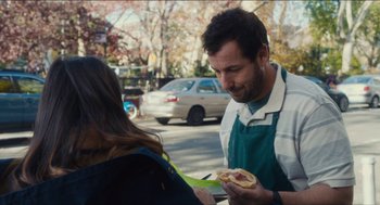 Movie still from “The Cobbler” (2014), directed by Tom McCarthy – A man holding a hot dog in his hand; Medium shot, Over the shoulder angle