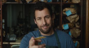 Movie still from “The Cobbler” (2014), directed by Tom McCarthy – A man holding a piece of food in his hand; Close Up shot, Over the shoulder angle