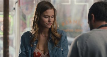 Movie still from “The Cobbler” (2014), directed by Tom McCarthy – A beautiful young woman wearing a jean jacket; Close Up shot, Over the shoulder angle