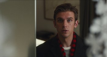 Movie still from “The Cobbler” (2014), directed by Tom McCarthy – A young man wearing a black jacket and a red necklace; Close Up shot, Over the shoulder angle
