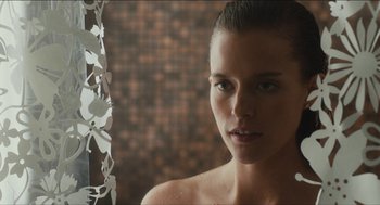 Movie still from “The Cobbler” (2014), directed by Tom McCarthy – A beautiful young woman standing in front of a mirror in a bathroom; Close Up shot, Over the shoulder angle