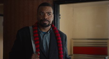 Movie still from “The Cobbler” (2014), directed by Tom McCarthy – A man with a red scarf around his neck; Close Up shot, Over the shoulder angle