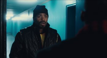 Movie still from “The Cobbler” (2014), directed by Tom McCarthy – A man wearing a black jacket and a black hat; Close Up shot, Over the shoulder angle