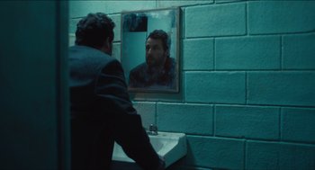 Movie still from “The Cobbler” (2014), directed by Tom McCarthy – A man standing in front of a bathroom mirror; Medium shot, Over the shoulder angle
