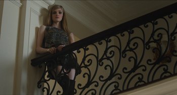 Movie still from “The Cobbler” (2014), directed by Tom McCarthy – A woman standing on the bottom of a railing; Medium shot, Low angle