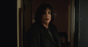 Movie still from “The Cobbler” (2014), directed by Tom McCarthy – A woman wearing a black jacket and a red tie; Close Up shot, Over the shoulder angle