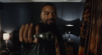 Movie still from “The Cobbler” (2014), directed by Tom McCarthy – A man holding a remote control in his hand; Close Up shot, Over the shoulder angle