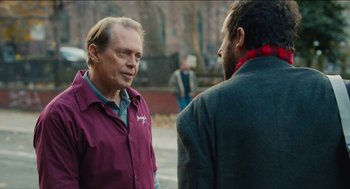 Movie still from “The Cobbler” (2014), directed by Tom McCarthy – Two men are talking on the sidewalk in a city; Close Up shot, Over the shoulder angle