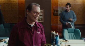 Movie still from “The Cobbler” (2014), directed by Tom McCarthy – A man sitting in front of a mirror in front of a table; Medium shot, Over the shoulder angle