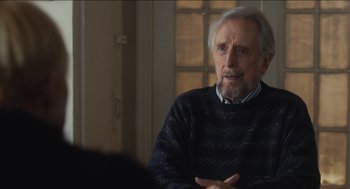 Movie still from “The Cobbler” (2014), directed by Tom McCarthy – An older man sitting at a table in front of a window; Close Up shot, Over the shoulder angle