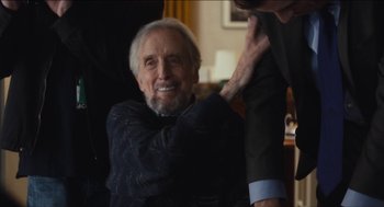 Movie still from “The Cobbler” (2014), directed by Tom McCarthy – An older man sitting in front of another man in a suit; Medium shot, Over the shoulder angle
