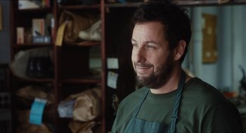 Movie still from “The Cobbler” (2014), directed by Tom McCarthy – A man with a beard wearing an apron; Close Up shot, Over the shoulder angle