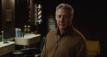 Movie still from “The Cobbler” (2014), directed by Tom McCarthy – An older man in a brown sweater in front of a barber chair; Close Up shot, Over the shoulder angle