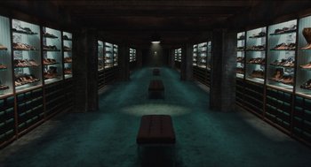 Movie still from “The Cobbler” (2014), directed by Tom McCarthy – A room filled with lots of books and benches; Extreme Wide shot, Overhead angle