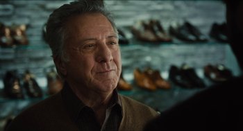 Movie still from “The Cobbler” (2014), directed by Tom McCarthy – An older man in a brown jacket looking at the camera; Close Up shot, Over the shoulder angle