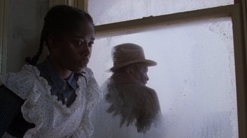 Movie still from “The Color Purple” (1985), directed by Steven Spielberg – A man and a woman looking out of a window; Close Up shot, Low angle