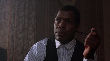Movie still from “The Color Purple” (1985), directed by Steven Spielberg – A black man is looking at a mirror; Close Up shot, Low angle