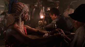 Movie still from “The Color Purple” (1985), directed by Steven Spielberg – A woman sitting at a table in front of a man; Medium shot, Over the shoulder angle