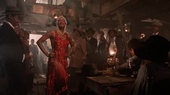 Movie still from “The Color Purple” (1985), directed by Steven Spielberg – A group of people standing around in a room; Wide shot, Low angle