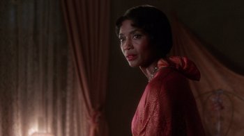 Movie still from “The Color Purple” (1985), directed by Steven Spielberg – A woman in a red dress is standing in front of a window; Close Up shot, Over the shoulder angle